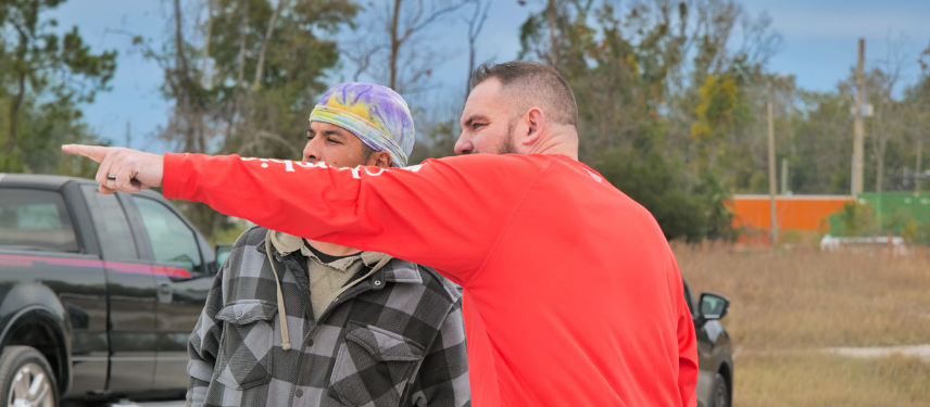 Shawn pointing toward training yard, student standing near