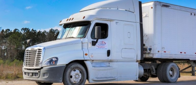 Front view of white Florida Truck Driving School semi truck